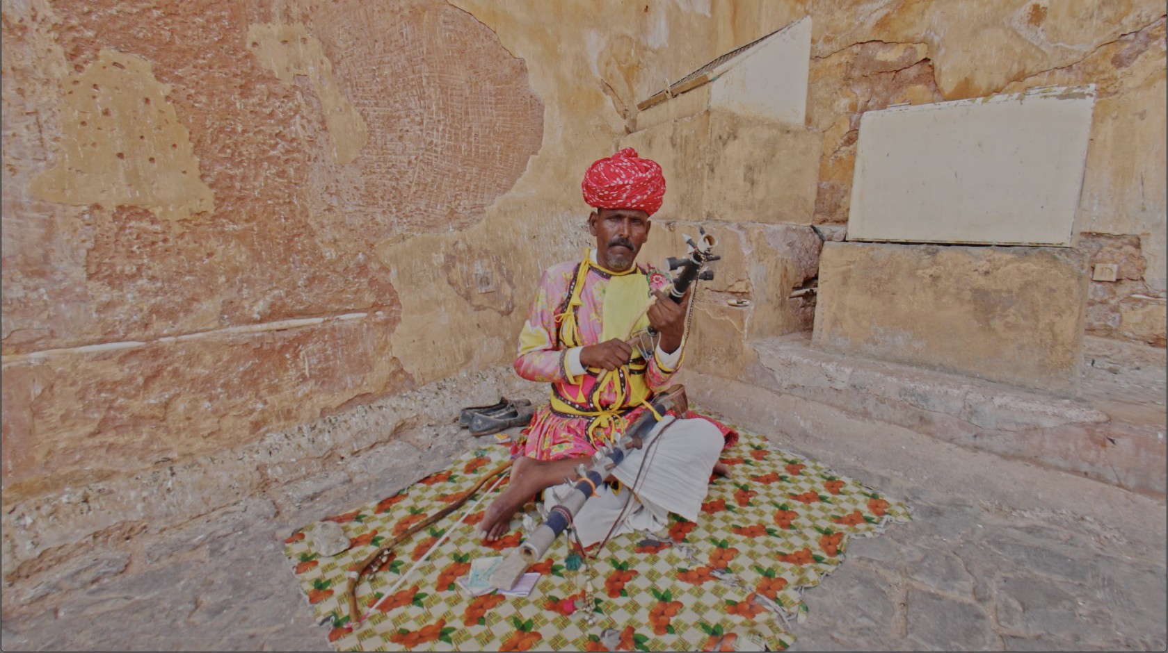 A folk musician playing a ravanahatha inside a Rajasthan fort, captured for Immersive India